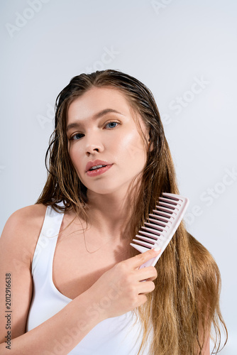 Fotografija Stunning portrait of a young woman showcasing modern hair care techniques