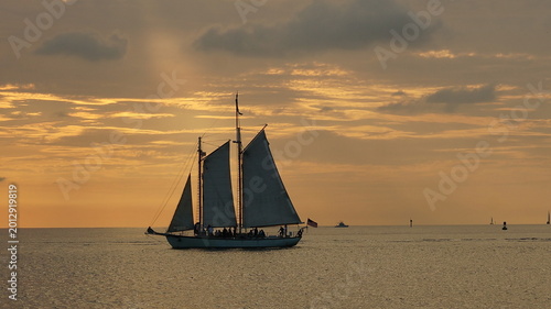 Sailboat Silhouette On Calm Ocean At Golden Sunset In Key West Florida USA Travel Scene