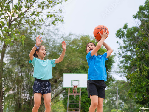 Active students practicing basketball drills during physical education class or after school sports program.