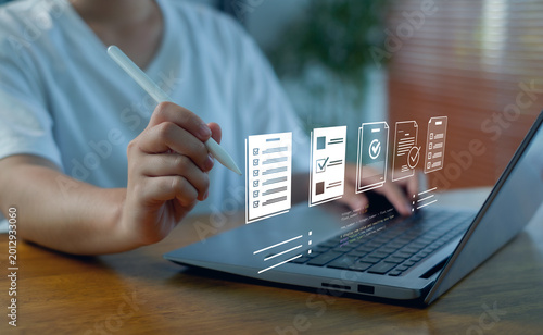 Bilde på lerret Business professional using tablet and stylus with checklist interface, document