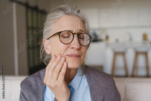 Senior woman suffering from toothache at home, elderly dental pain, oral health problem, healthcare concept, discomfort, sensitive teeth and medical care need