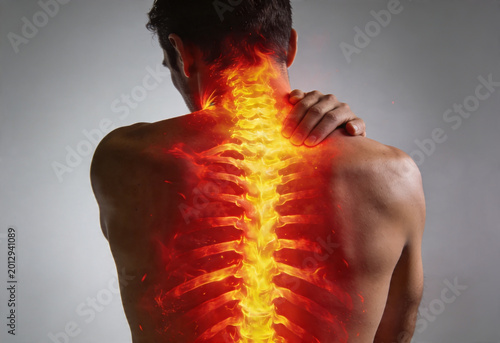 Man experiencing severe neck and upper back pain with fiery inflammation along spine anatomy medical.