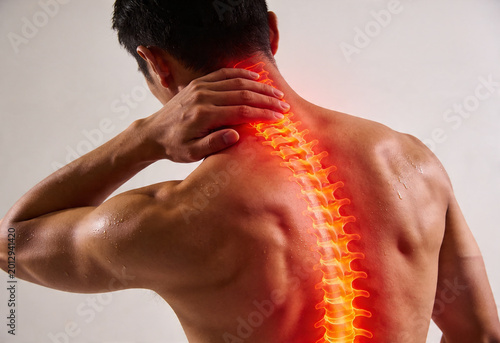 Man holding neck experiencing pain inflammation ache nerve cervical spine person health medicine backview anatomy.