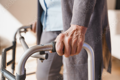 Foto Close up of senior woman hands holding walker at home, elderly mobility support,
