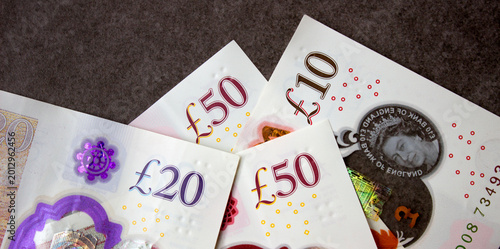 British pounds close-up on a chessboard background. National currency of Great Britain