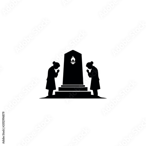 Fotografía Two people bowing to a memorial monument with a flame.