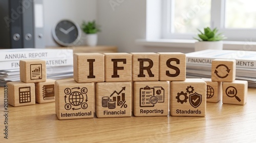 A wooden table displays a stack of wooden blocks arranged to spell the acronym 