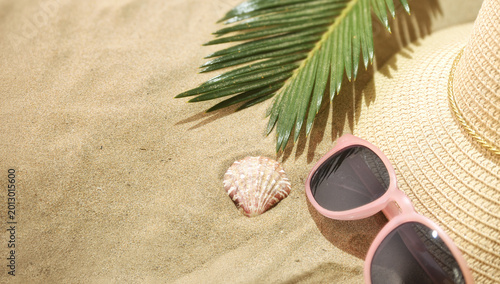 Pink Sunglasses and Straw Hat on Sand
