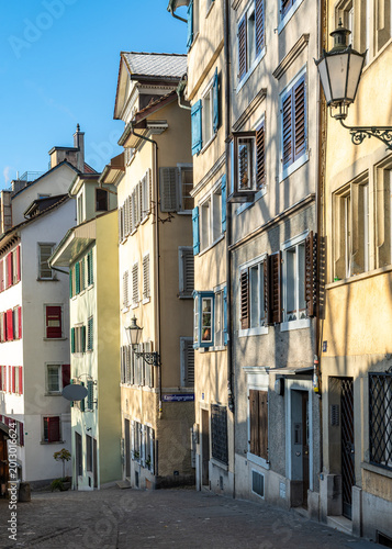 Narrow cobblestone street in Zurich old town with typical colorful houses, Switzerland