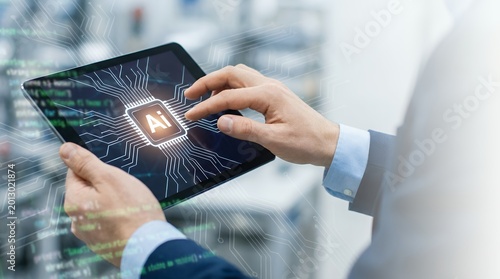 Person's hands interacting with a tablet displaying glowing artificial intelligence chip graphic and abstract digital code elements 179 characters AI technology circuit computer
