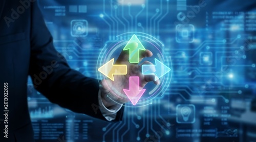 A businessman's hand interacts with a glowing holographic interface displaying directional arrows and circuit board graphics symbolizing decision making and technology choice