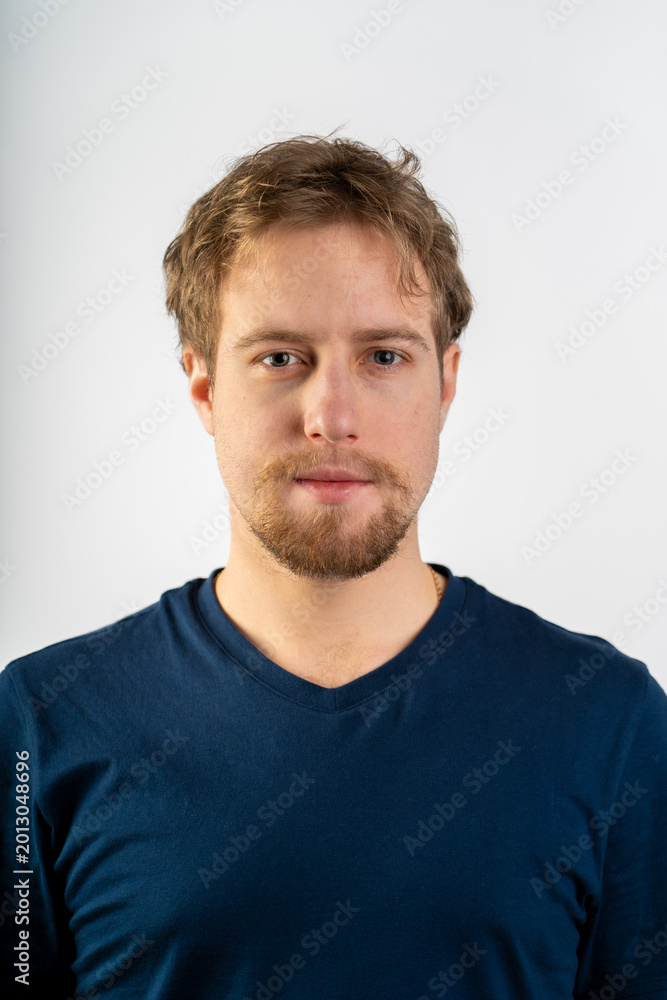 Fototapeta premium Young bearded man looking at camera on white background