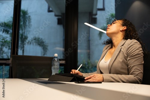 Bild auf Leinwand Professional woman feeling tired and overwhelmed at work