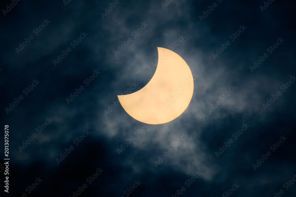 Fototapeta premium Solar eclipse view through a telescope and a special solar filter.