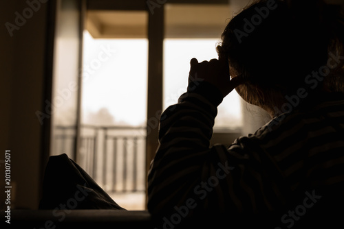 Canvas Print Woman with headache, depression, sadness and loneliness at home.