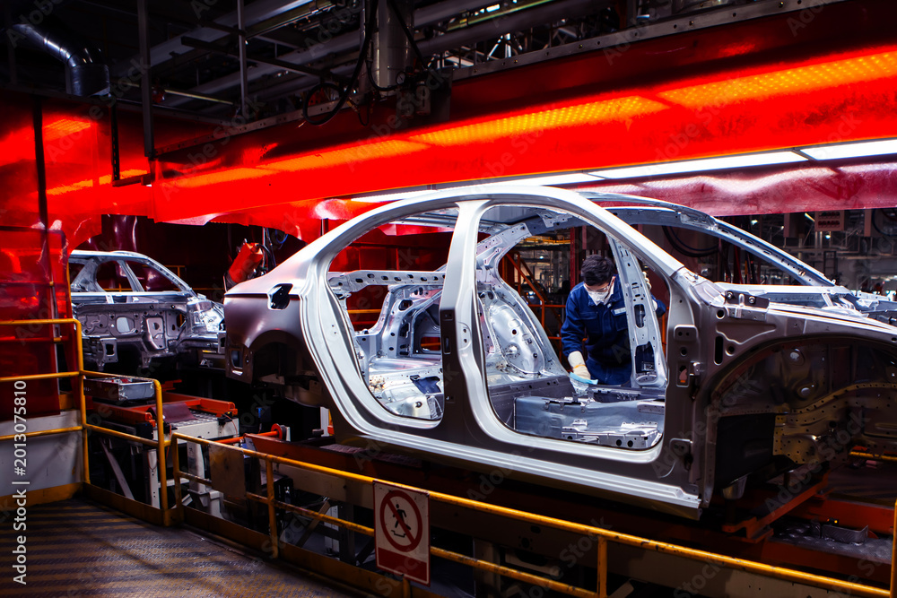 Naklejka premium Asian workers are working on an automobile body production line factory.