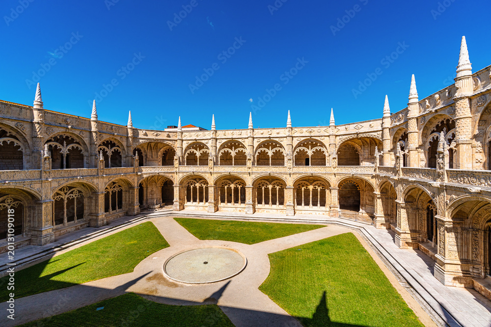 Naklejka premium Cloister of Jeronimos Monastery in Lisbon Portugal with ornate arches and historic Manueline architecture, famous UNESCO landmark and popular travel destination