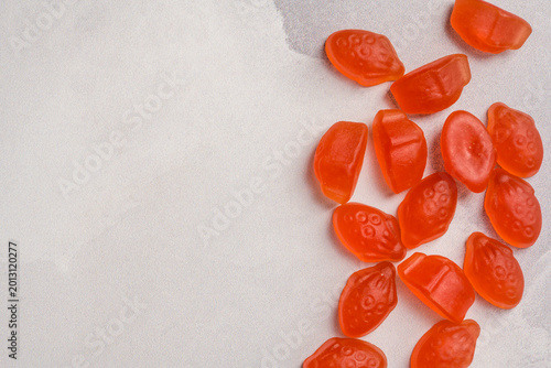 Obraz na plátně Jelly gummy strawberries fruit vitamins on bright background, food supplements