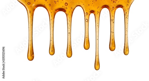 A close-up view of golden honey dripping down with bubbles on a white background