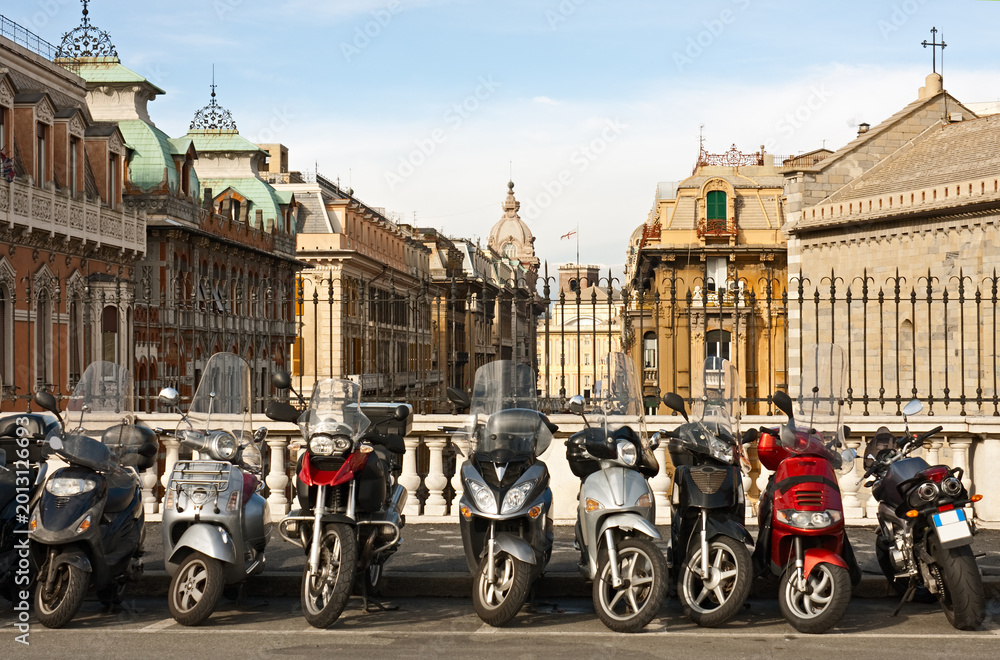 Naklejka premium Motorcycles parked over Genova downtown, Italy.
