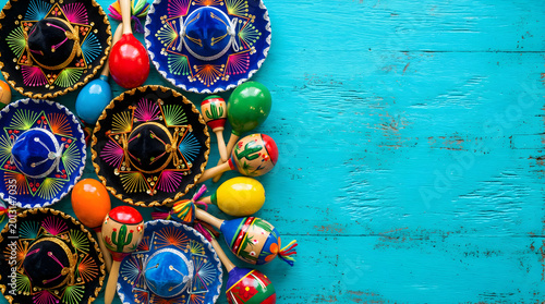 Vibrant Mexican Fiesta Sombreros and Maracas on Blue Wooden Background