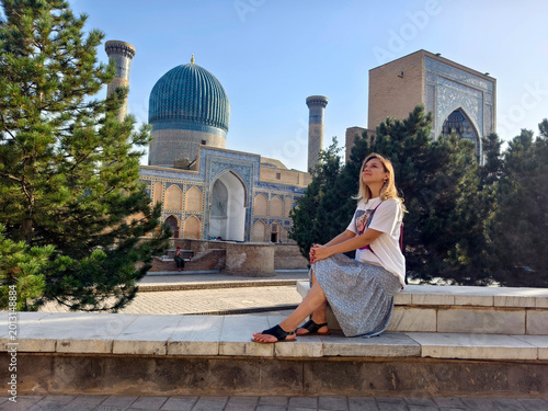 Konstfotografi Female tourist sitting in front of Gur Emir mausoleum in Samarkand, Uzbekistan