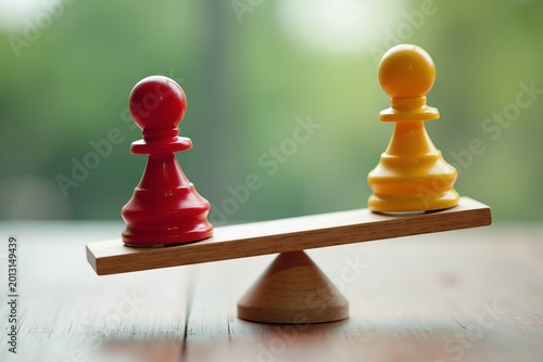 Teamwork and Balance in Business: Close-up Shot of Red and Yellow Pawn Figures on a Wooden Seesaw