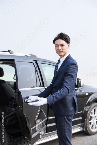 Valokuva Professional Chauffeur Opening Luxury Car Door