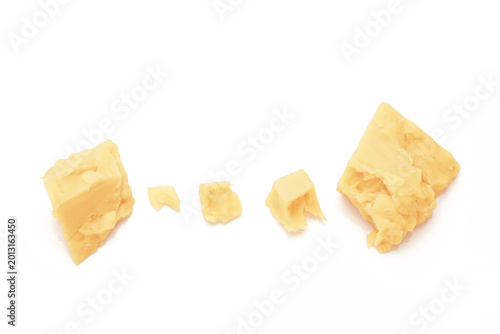 Broken Chunks of White Cheddar Cheese on white background