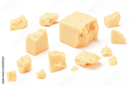 Broken Chunks of White Cheddar Cheese on white background