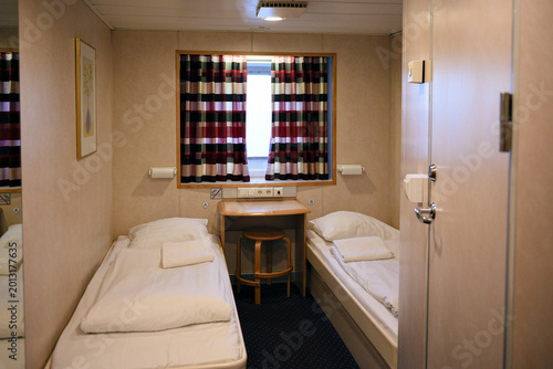 Bild auf Leinwand Compact ferry cabin interior with twin beds and small window