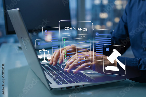 Close up of Businessman working on Regulatory Compliance and Legal Audit via Digital Holographic Dashboard on Laptop