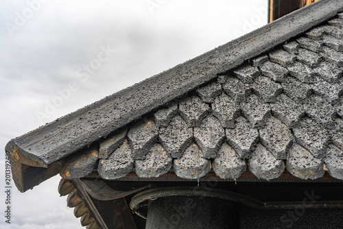 Pagan dragon heads and Christian crosses on the roof of the stave church in Norway. Authentic traditional Norwegian stabbur (raised wooden storehouse) in the rural landscape of Rjukan, Telemark.