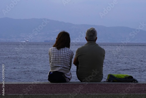 Fényképezés An elderly couple sits by the sea