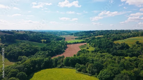Discover France's countryside with stunning aerial views of lush fields and vibrant greenery under sunny skies