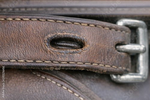 A close-up shot of a leather bag with a metal buckle, suitable for use in travel or adventure-themed designs