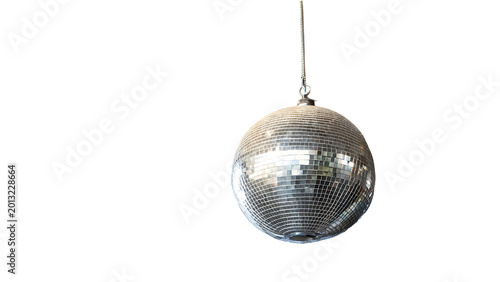 A shiny silver disco ball hangs from a string on white background with bright reflections
