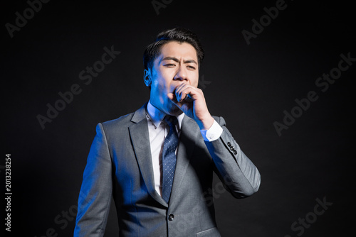 Photos Tired Businessman Yawning in Suit on Dark Background