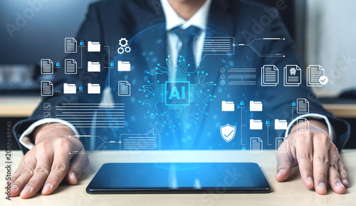 Photography A business professional interacts with a tablet showcasing AI icons and digital documents, representing a modern approach to technology and innovation in the office