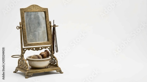 Antique vanity mirror with ornate golden frame and bowl of toiletries