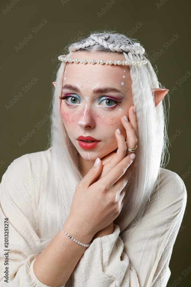 Fototapeta premium Beautiful elf girl on dark olive background
