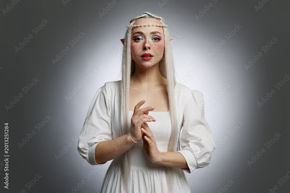 Fototapeta premium Beautiful elf girl on grey gradient background