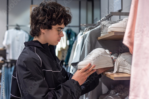 Quadro em tela Teenage Boy Shopping for Sneakers in Shoe Store - Youth Fashion Footwear Consumer and Retail Shopping