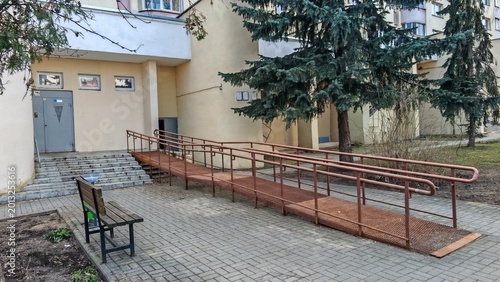 Bild auf Leinwand To allow people with disabilities to enter the building, an inclined ramp made of metal with handrails was made