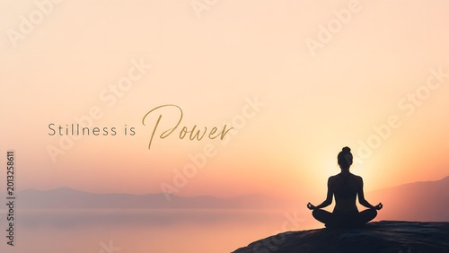 Silhouette of Woman Meditating by Lake at Sunset with Quote Stillness is Power for International Yoga Day Concept