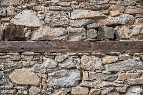 Картината върху платно Timber in a rough cut stone wall.