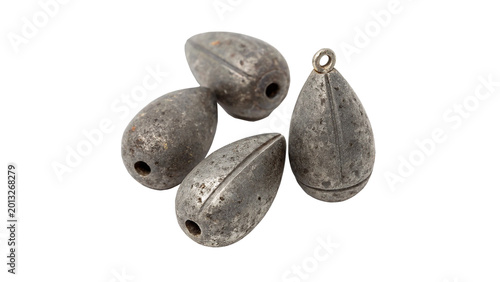Tableau sur toile Three small metallic lead fishing weights or sinkers with a round teardrop shape