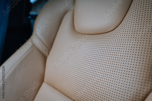 Schilderij op canvas Close-up of luxury car leather seat with perforated design and soft beige uphols