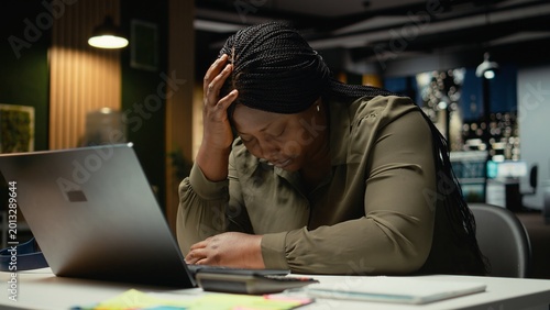 Bild auf Leinwand African american drained woman experiencing weariness after hours at desk, falling asleep with head in her palm