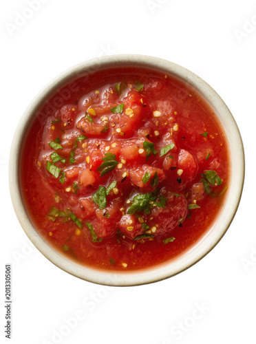 Fotografie Isolated ceramic bowl with vibrant chunky tomato salsa and fresh green herbs, re